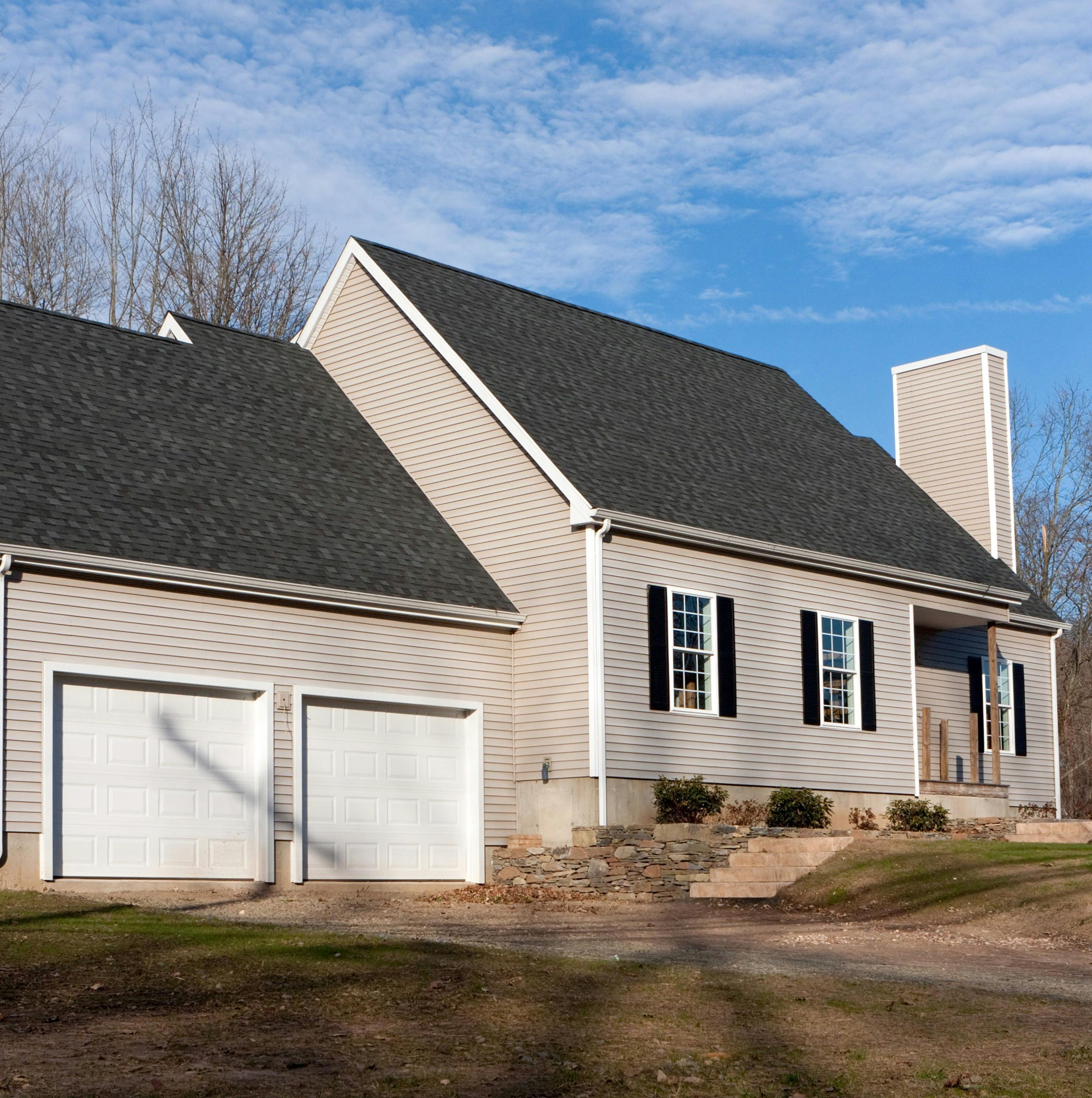 A cape code style home with vinyl siding