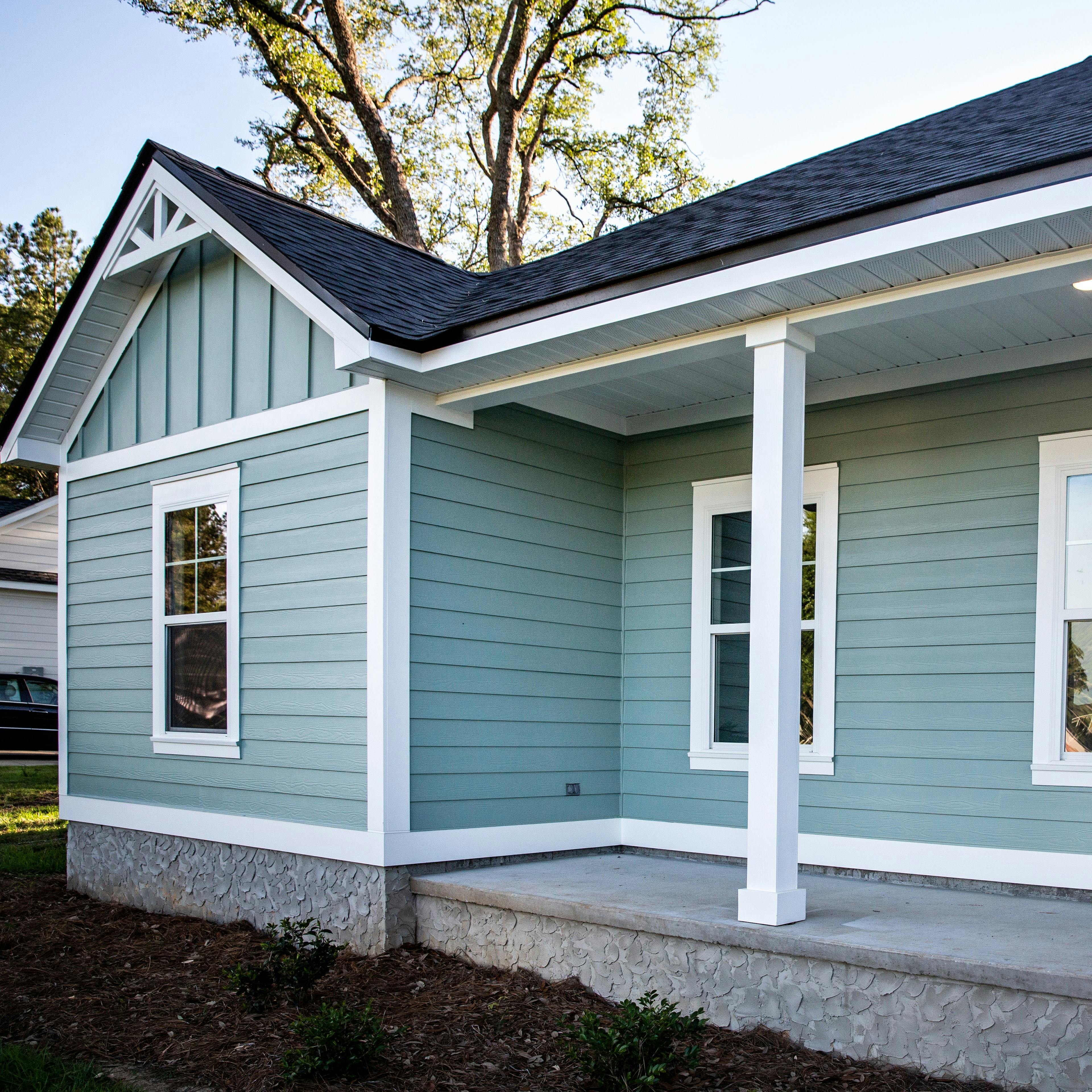 A ranch style home with vinyl siding along a porch