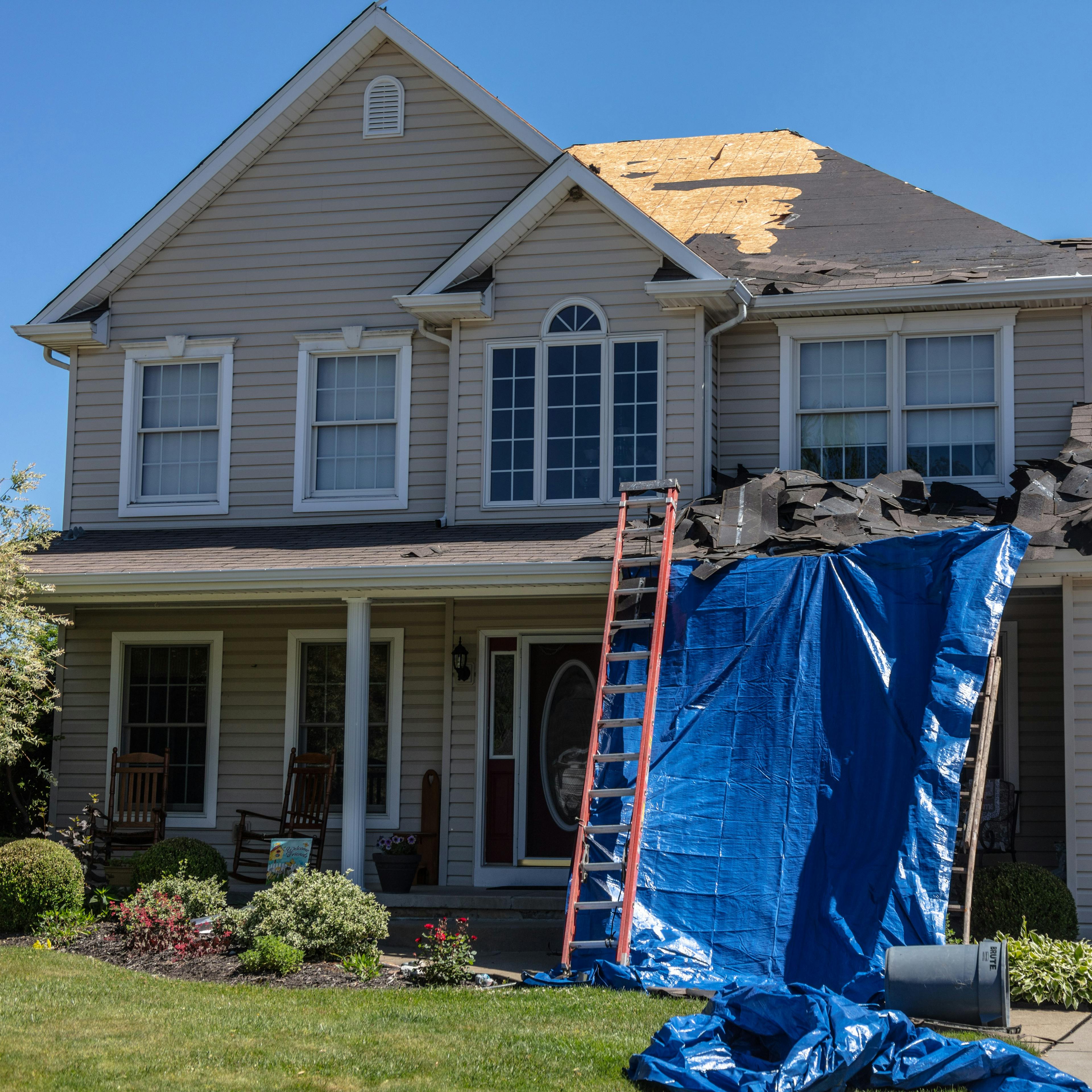 An asphalt roof being stripped of shingles